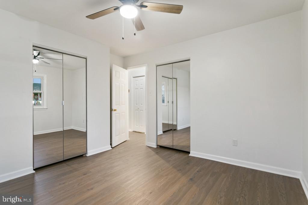 9 Oberlin Road Pennsville, NJ 08070 - Photo 15 of 23 an empty room with wooden floor and ceiling fan
