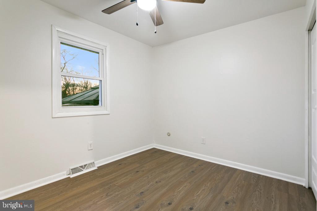 9 Oberlin Road Pennsville, NJ 08070 - Photo 17 of 23 an empty room with wooden floor and windows