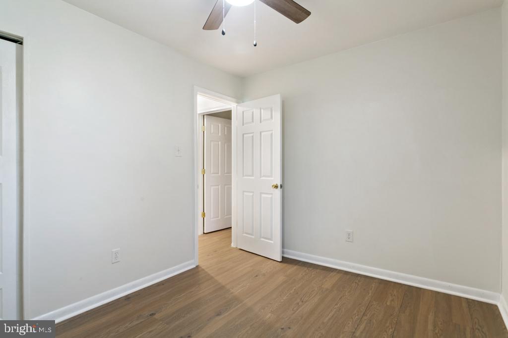 9 Oberlin Road Pennsville, NJ 08070 - Photo 18 of 23 an empty room with a ceiling fan and wooden floor