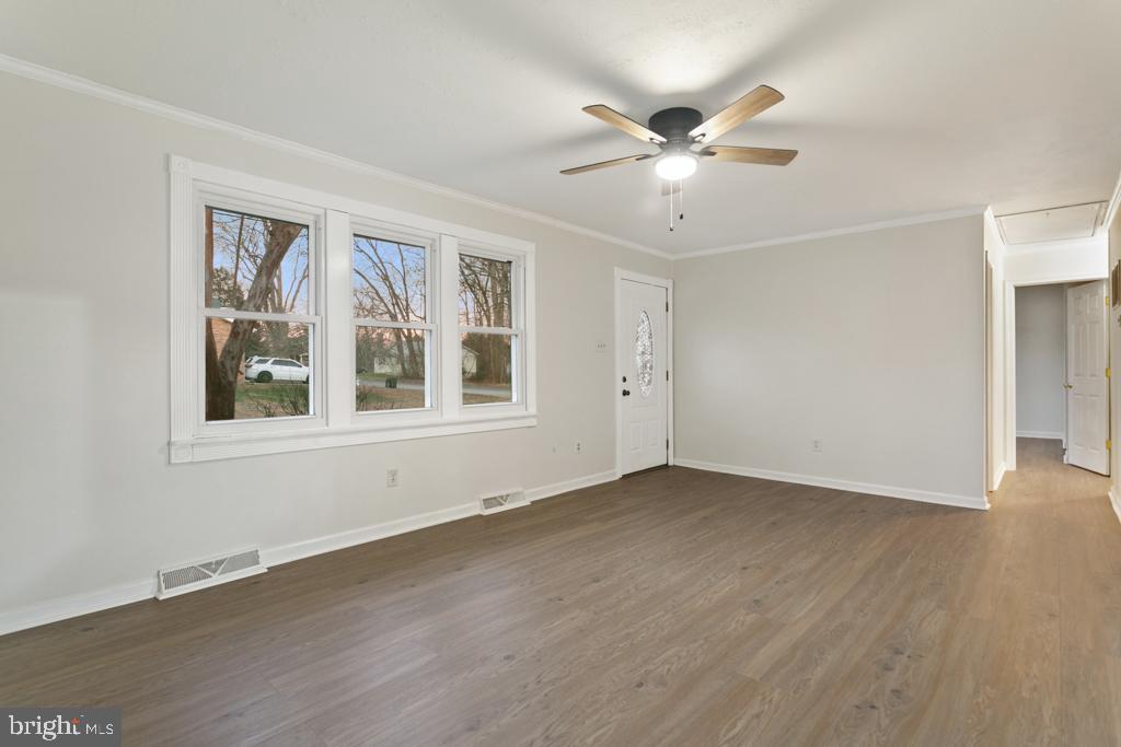 9 Oberlin Road Pennsville, NJ 08070 - Photo 8 of 23 a view of an empty room with wooden floor and a window