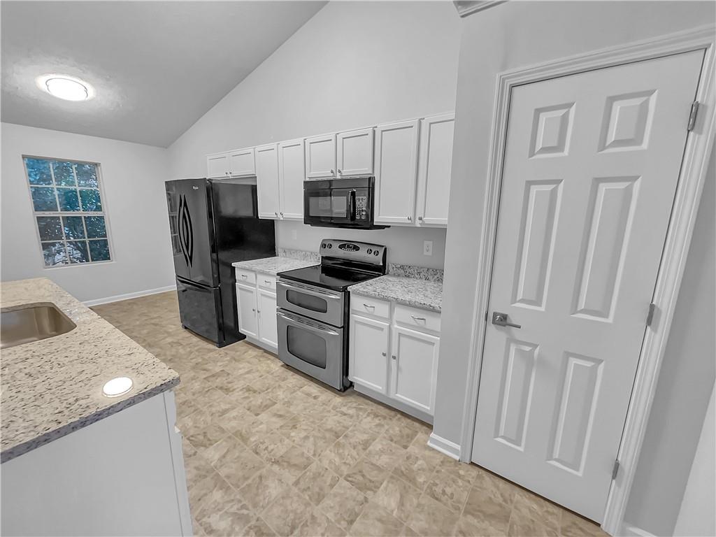 3624 Summit Pines Decatur, GA 30034 - Photo 9 of 21 a kitchen with white cabinets and stainless steel appliances