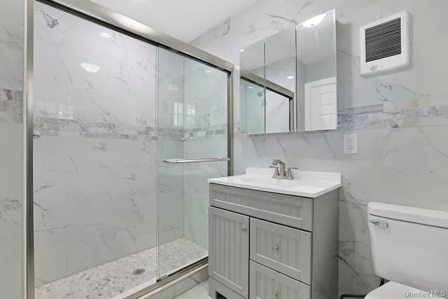 a bathroom with a toilet sink and a shower