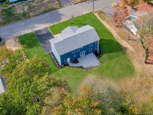 a view of a house with a yard patio and sitting area