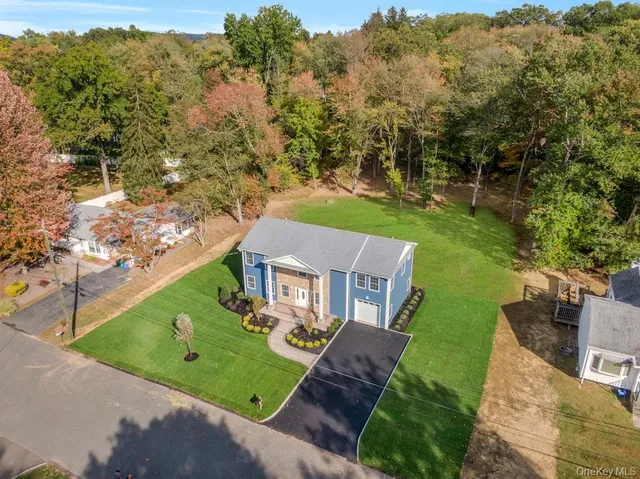 an aerial view of a house with a garden and swimming pool