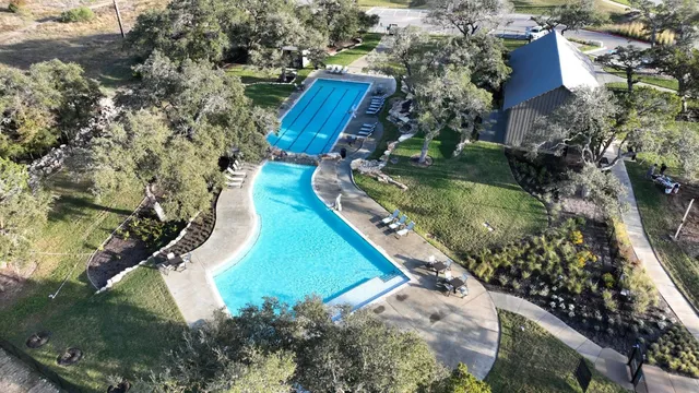 a view of a swimming pool and lounge chairs