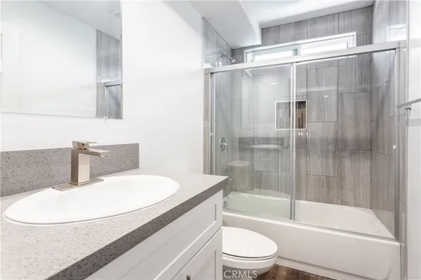 a bathroom with a sink a toilet and a bathtub