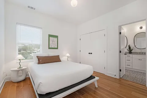 a bedroom with a bed and a lamp