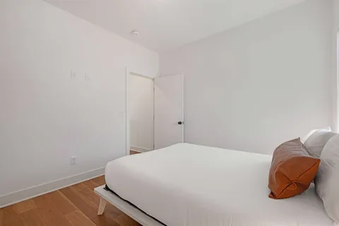 a bedroom with a bed and window