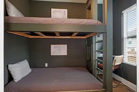 a bedroom with a bed potted plant and a chair