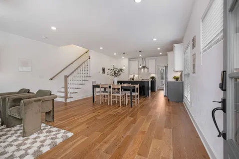 a view of a kitchen with dining room and wooden floor