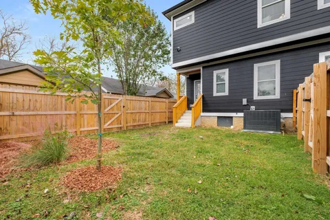 a view of a backyard with wooden fence