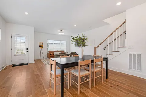 a dining room with furniture and wooden floor