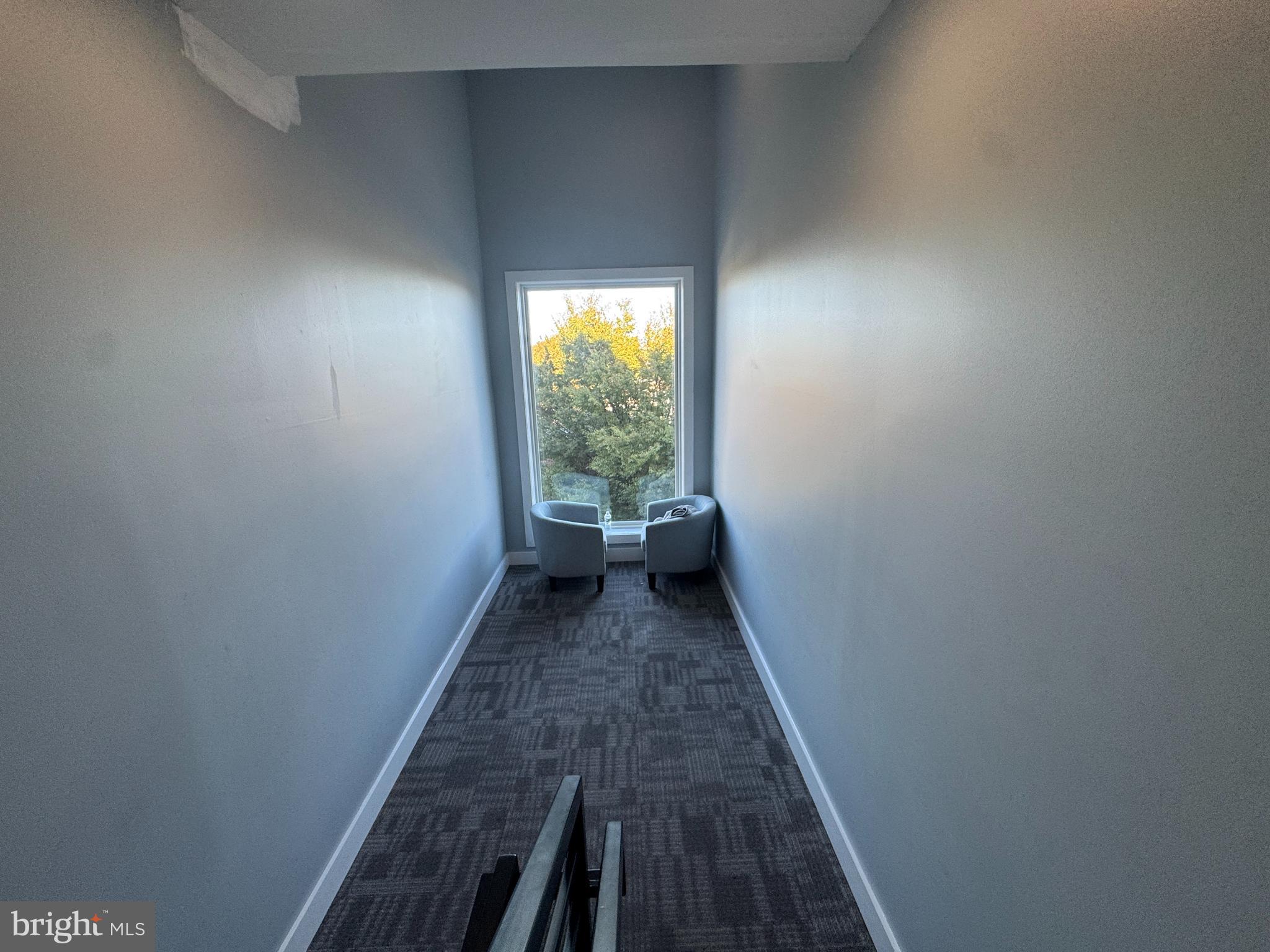 6610 Germantown Avenue, Unit LL6 Philadelphia, PA 19119 - Photo 19 of 38 a view of a hallway with wooden floor and a carpet