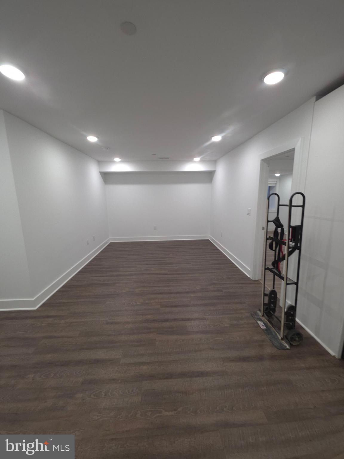 6610 Germantown Avenue, Unit LL6 Philadelphia, PA 19119 - Photo 25 of 38 an empty room with wooden floor and windows