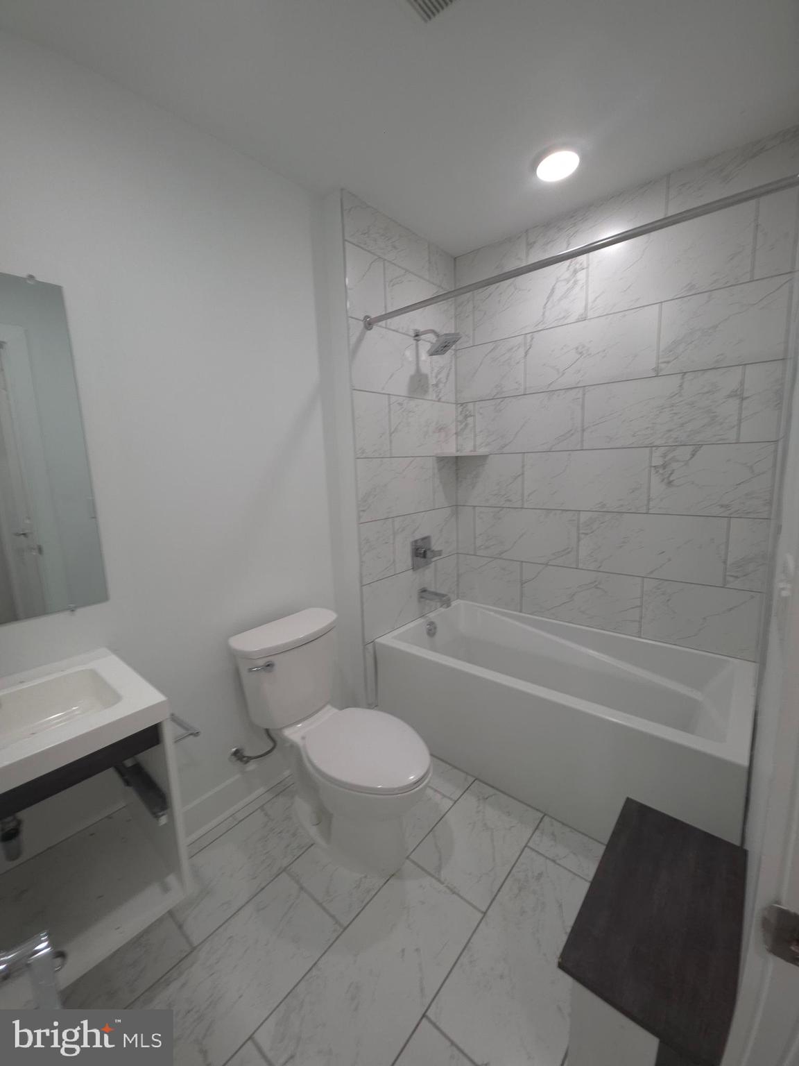 6610 Germantown Avenue, Unit LL6 Philadelphia, PA 19119 - Photo 33 of 38 a bathroom with a sink a toilet and bathtub