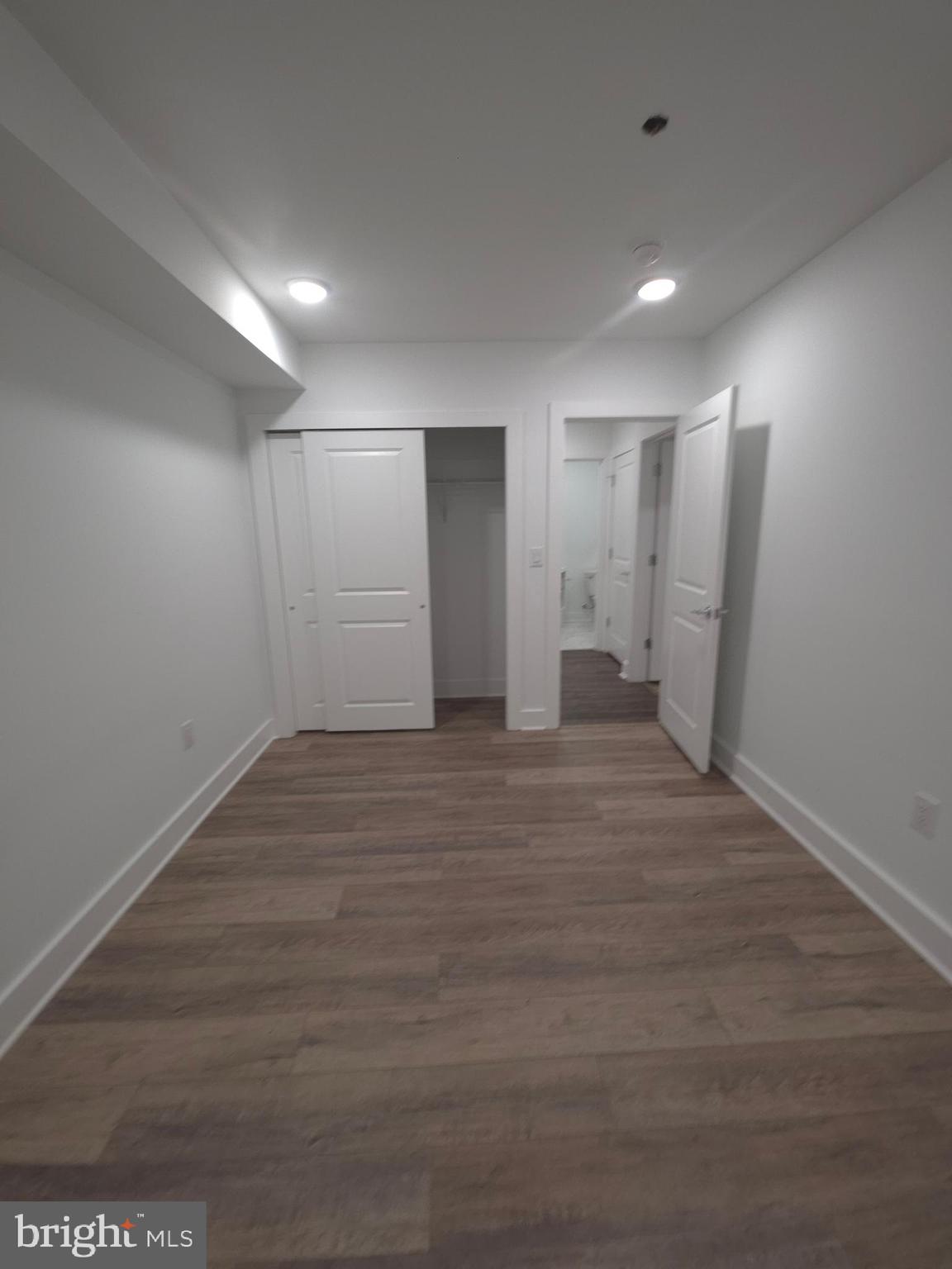 6610 Germantown Avenue, Unit LL6 Philadelphia, PA 19119 - Photo 35 of 38 an empty room with wooden floor and bathroom