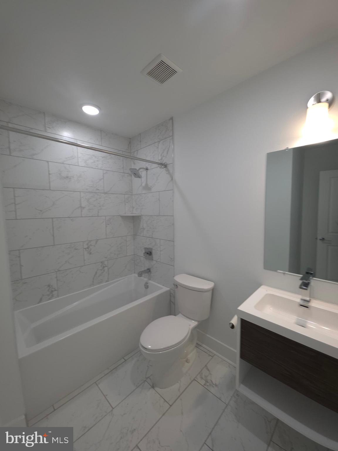 6610 Germantown Avenue, Unit LL6 Philadelphia, PA 19119 - Photo 37 of 38 a bathroom with a sink a toilet and shower