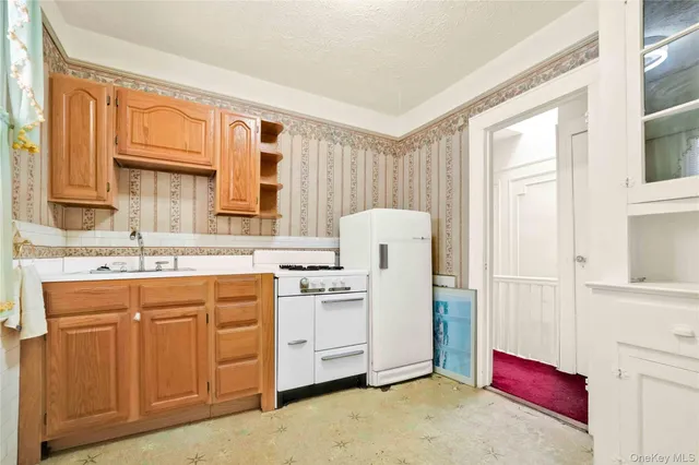 a kitchen with a stove a sink and a refrigerator