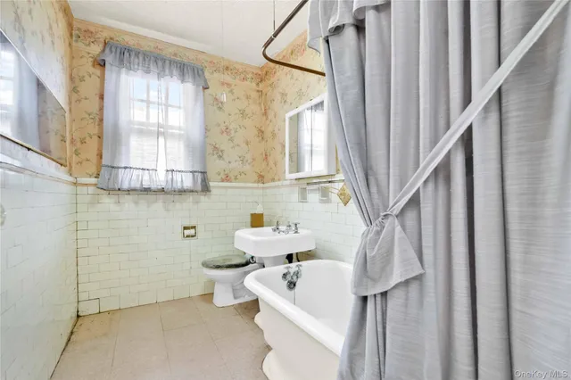 a bathroom with a sink a toilet and a bathtub