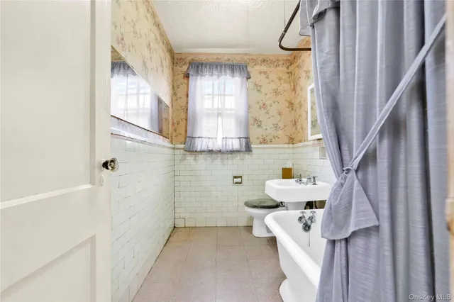 a bathroom with a sink a toilet and tub