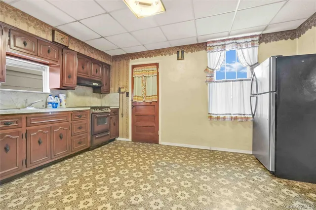 a kitchen with stainless steel appliances granite countertop a refrigerator and a sink
