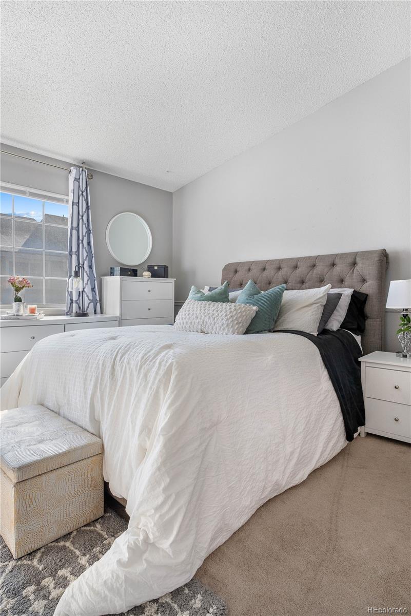 5155 West 68th Avenue, Unit 5 Westminster, CO 80030 - Photo 13 of 33 a bedroom with a bed and a couch