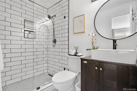 a bathroom with a sink toilet a mirror and vanity