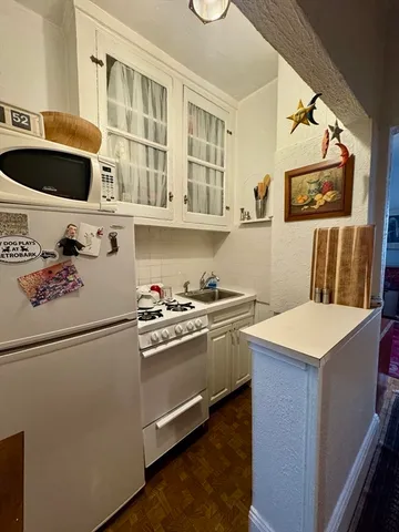 a room with furniture a flat screen tv and a window