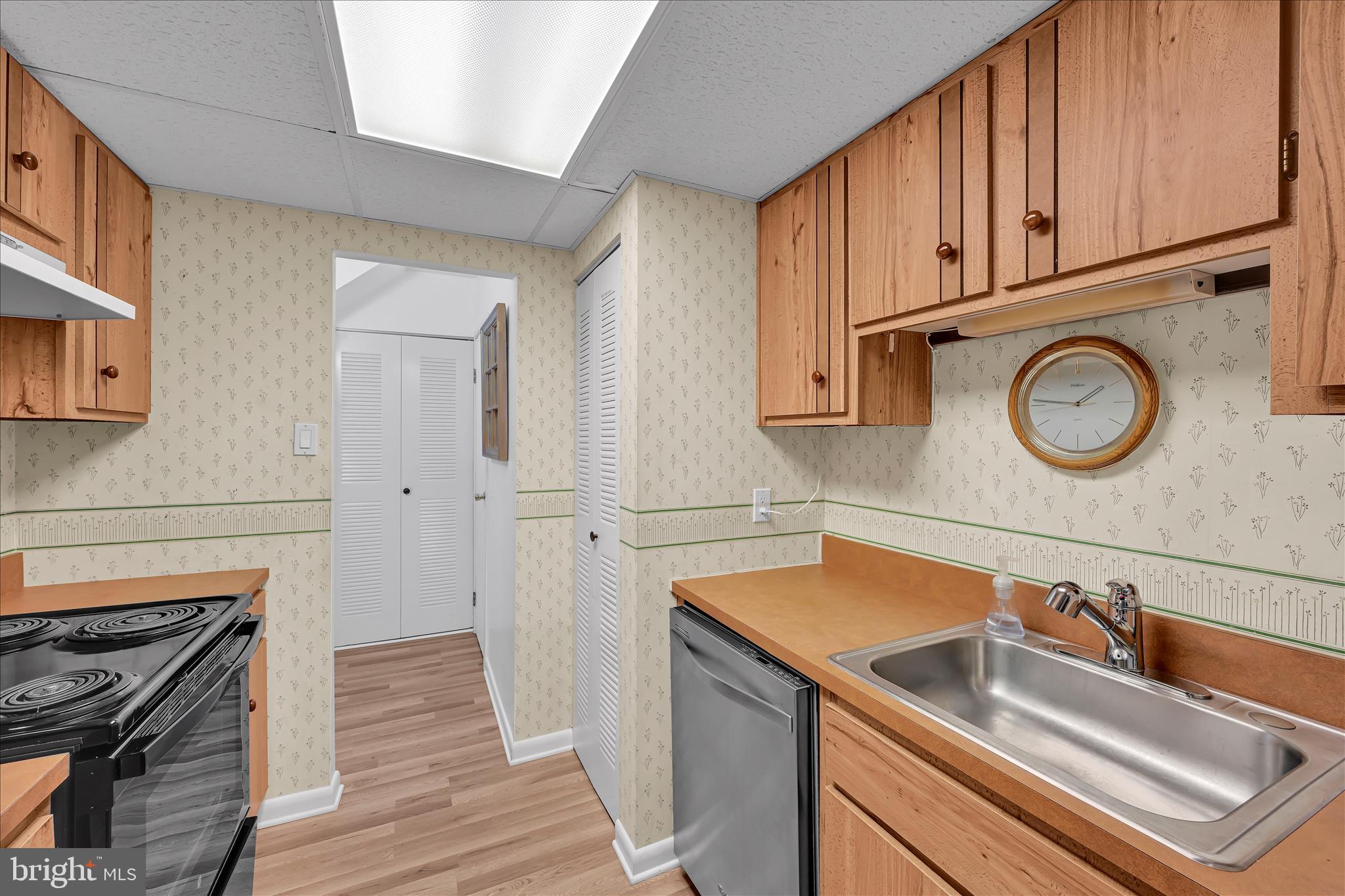 402 Village Walk, Unit 402 Exton, PA 19341 - Photo 11 of 27 a kitchen with stainless steel appliances granite countertop a sink and cabinets with wooden floor