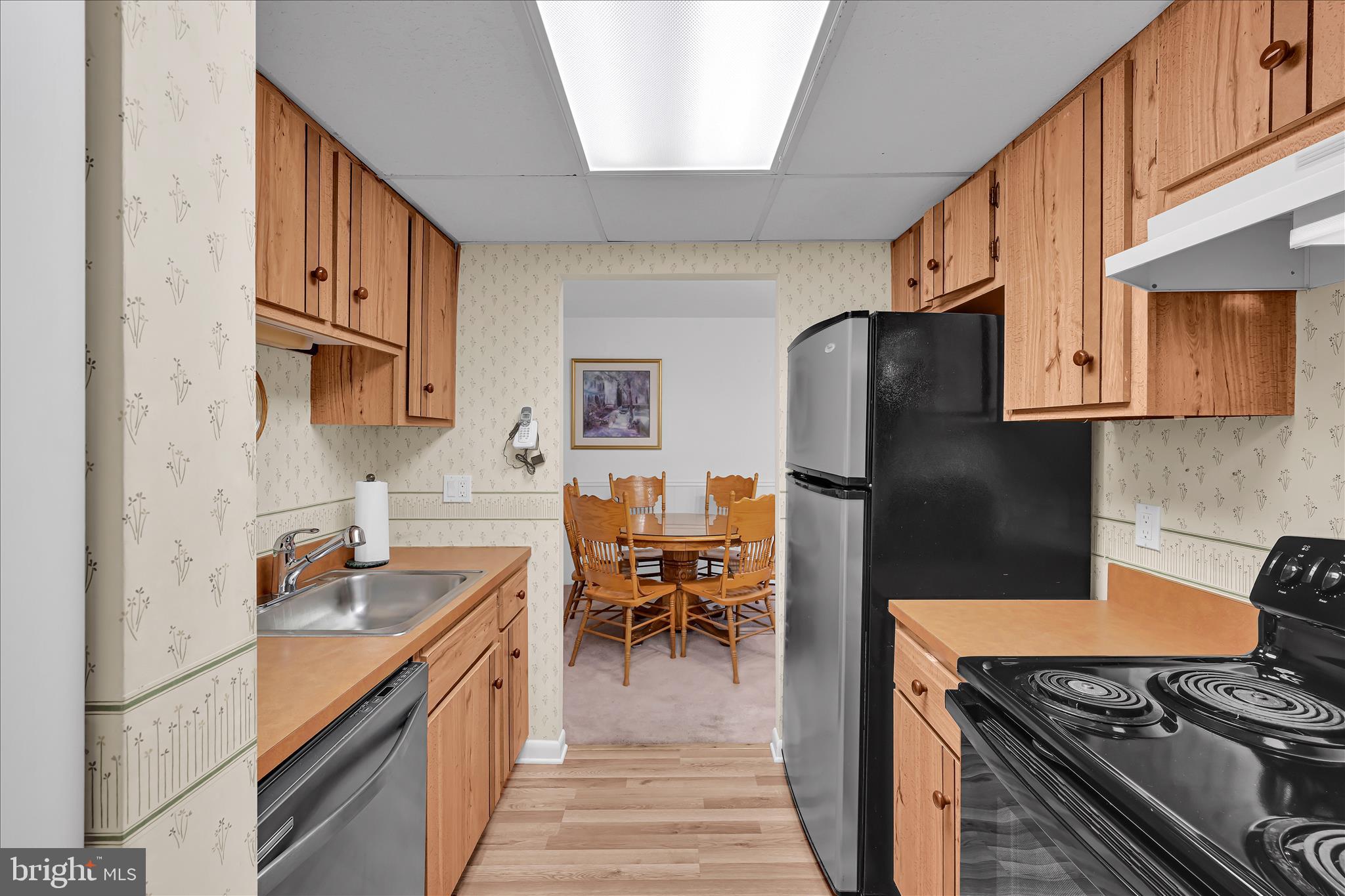 402 Village Walk, Unit 402 Exton, PA 19341 - Photo 12 of 27 a kitchen with stainless steel appliances granite countertop a refrigerator stove and sink