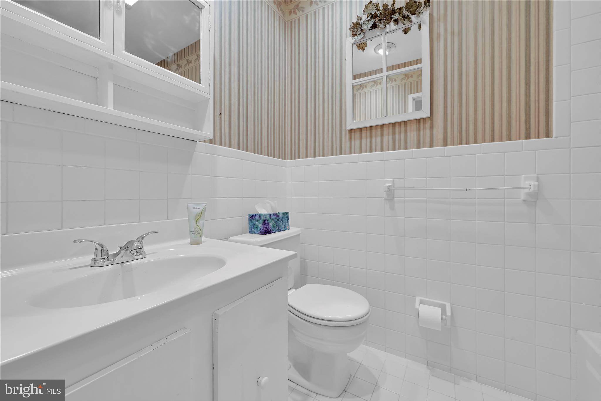 402 Village Walk, Unit 402 Exton, PA 19341 - Photo 19 of 27 a bathroom with a sink a toilet and mirror