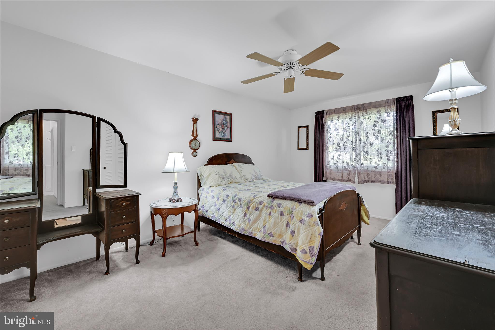 402 Village Walk, Unit 402 Exton, PA 19341 - Photo 20 of 27 a bedroom with a bed a table and painting