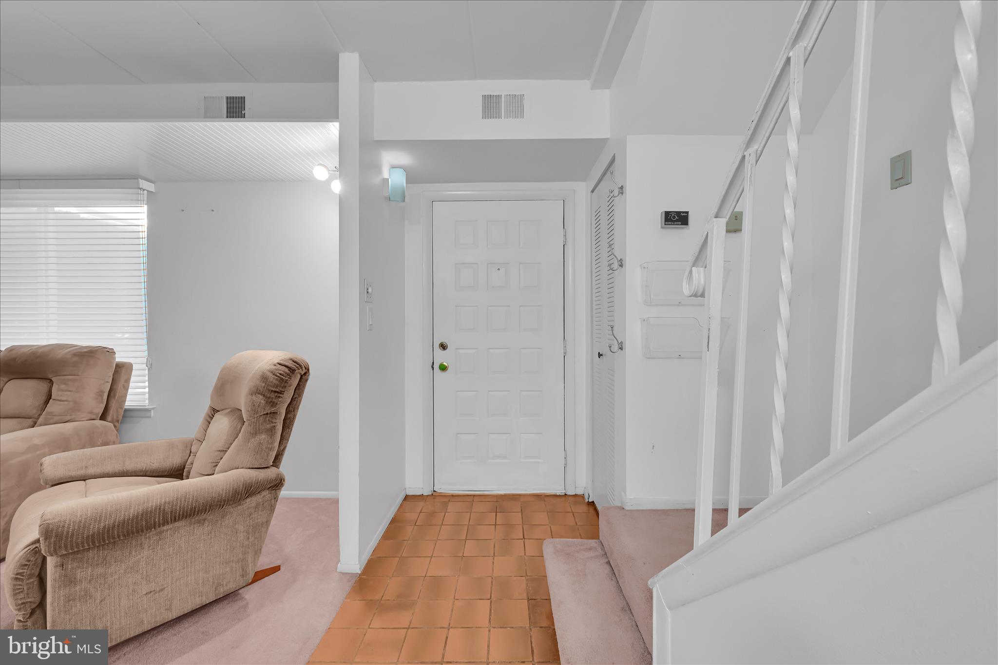 402 Village Walk, Unit 402 Exton, PA 19341 - Photo 2 of 27 a hallway with furniture and a chandelier