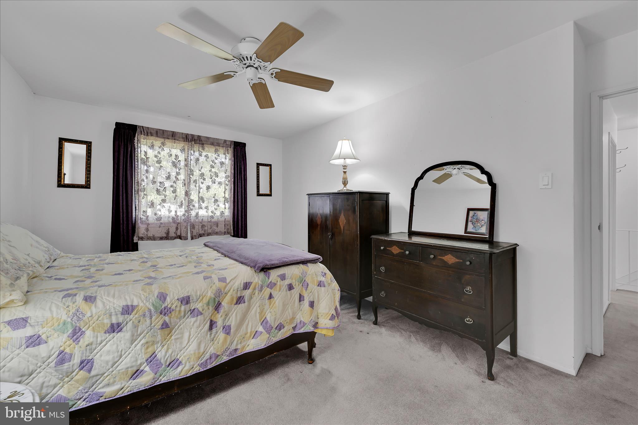 402 Village Walk, Unit 402 Exton, PA 19341 - Photo 21 of 27 a bedroom with a bed and a dresser with mirror