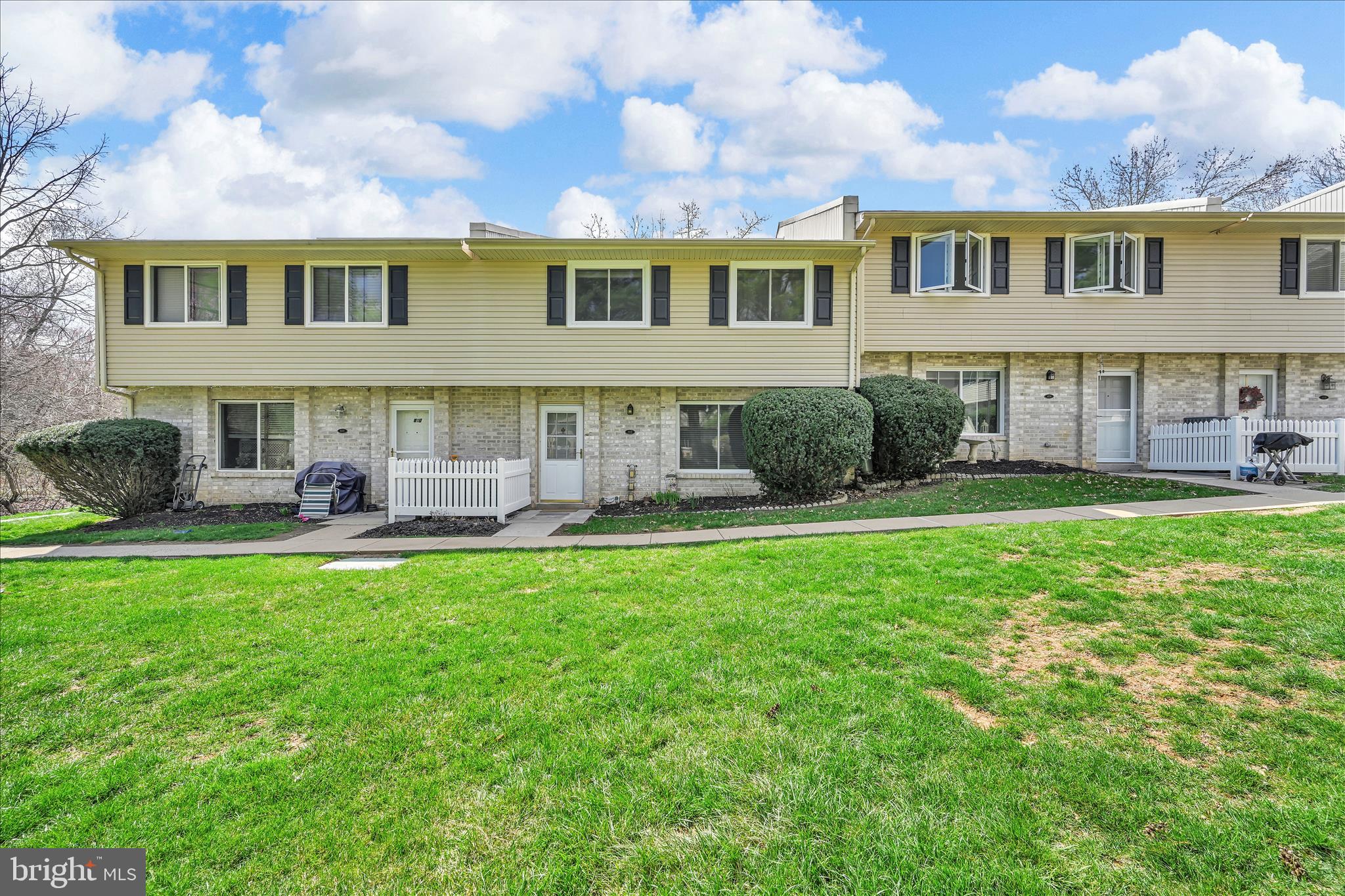 402 Village Walk, Unit 402 Exton, PA 19341 - Photo 24 of 27 a front view of a house with yard and green space
