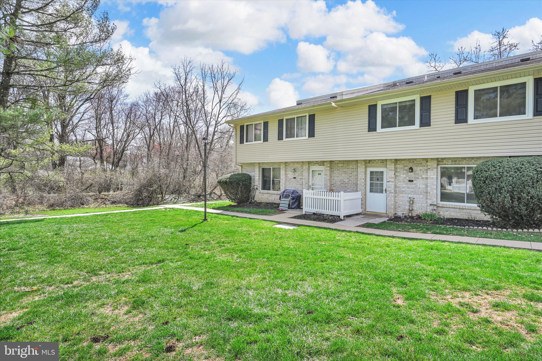 402 Village Walk, Unit 402 Exton, PA 19341 - Photo 26 of 27 a backyard of a house with table and chairs