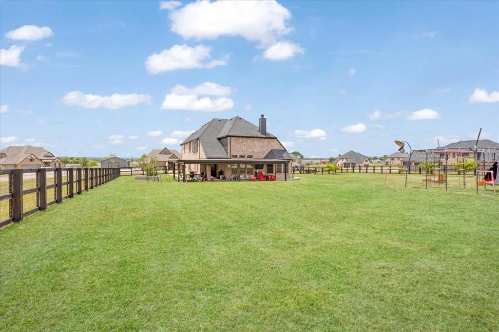 1205 Redbud Street Howe, TX 75459 - Photo 32 of 40 a view of a big house with a big yard and large trees