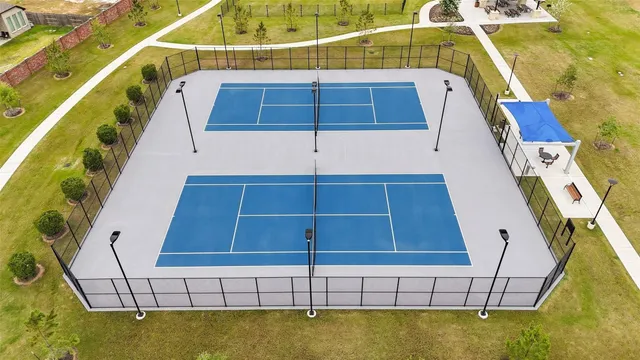 a view of swimming pool with lawn chairs under an umbrella