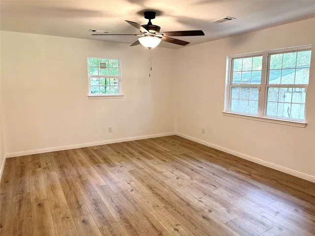 wooden floor in an empty room with a window