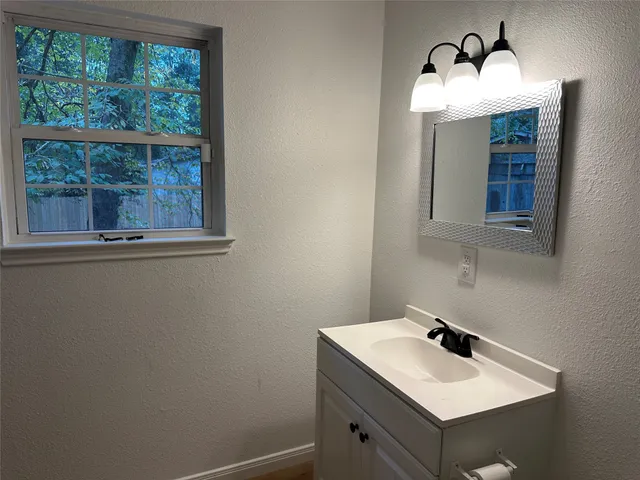 a bathroom with a sink and mirror