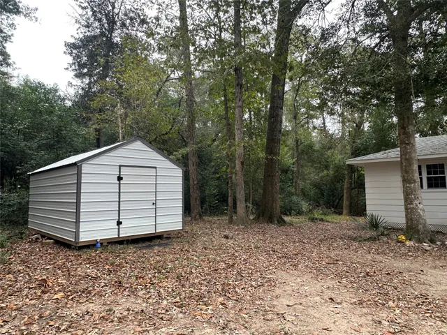 a view of backyard and trees