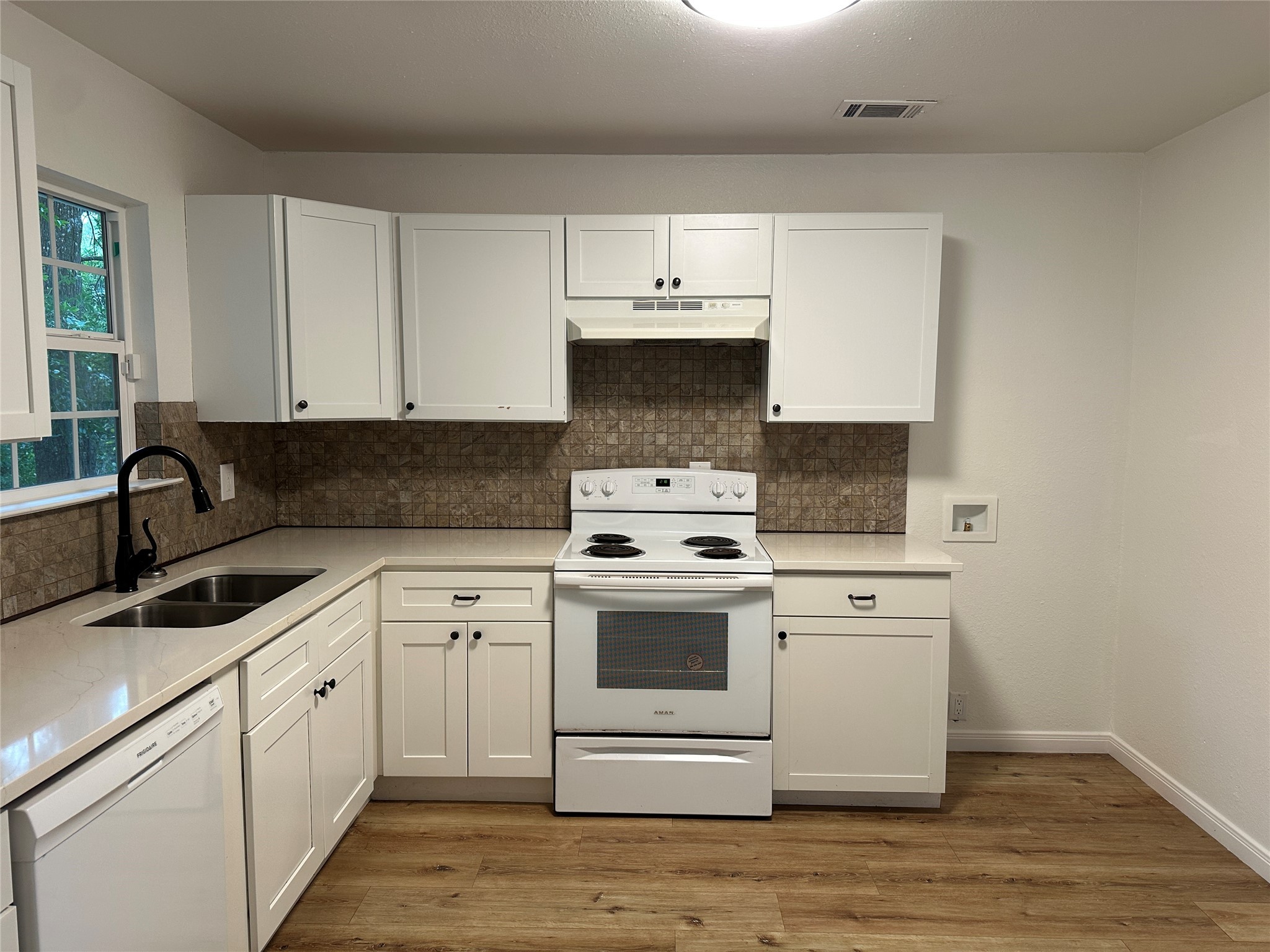 146 Barbara Lane Shepherd, TX 77371 - Photo 7 of 20 a kitchen with a sink stove and cabinets