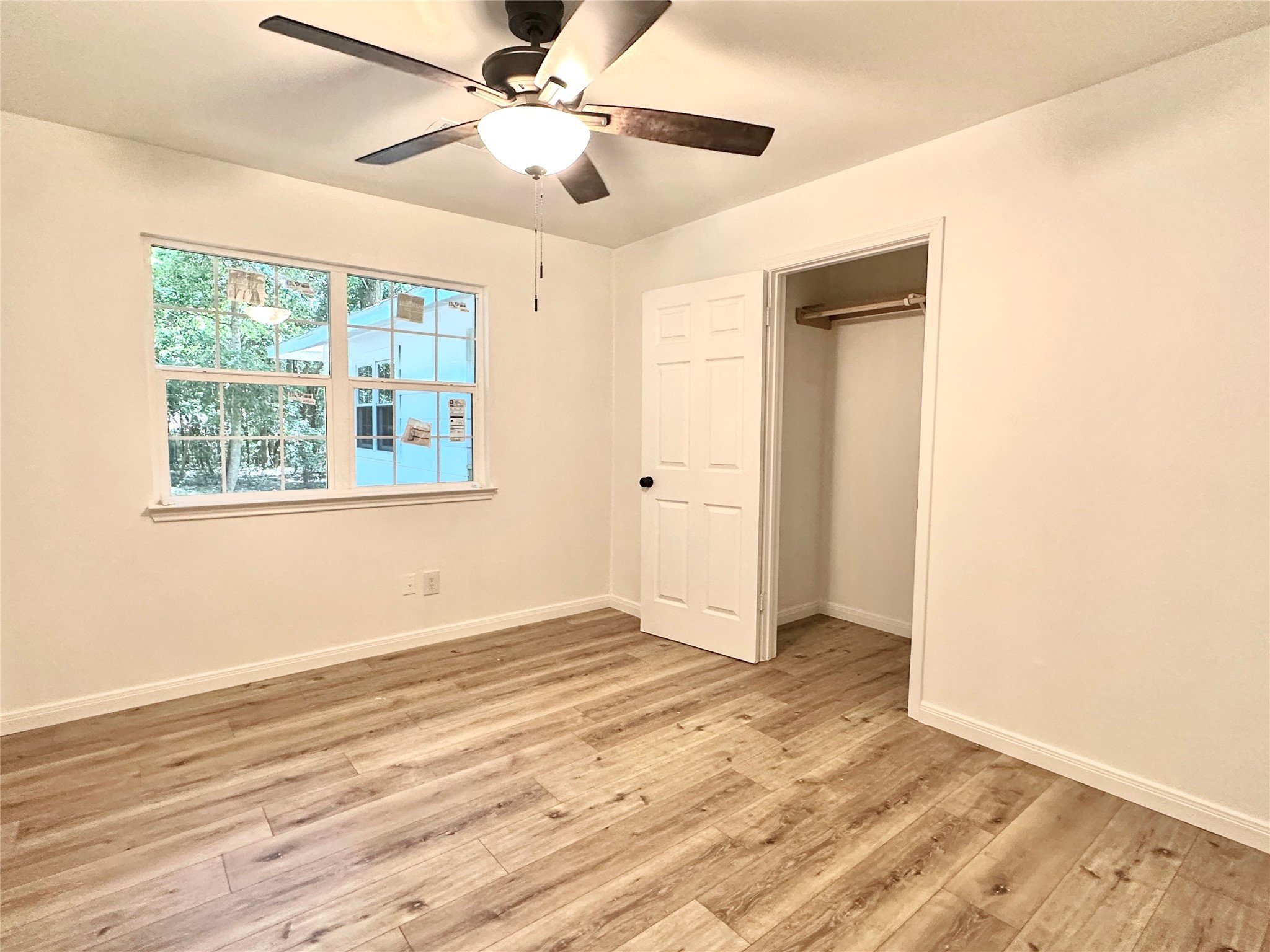 146 Barbara Lane Shepherd, TX 77371 - Photo 9 of 20 a view of an empty room with wooden floor and a window
