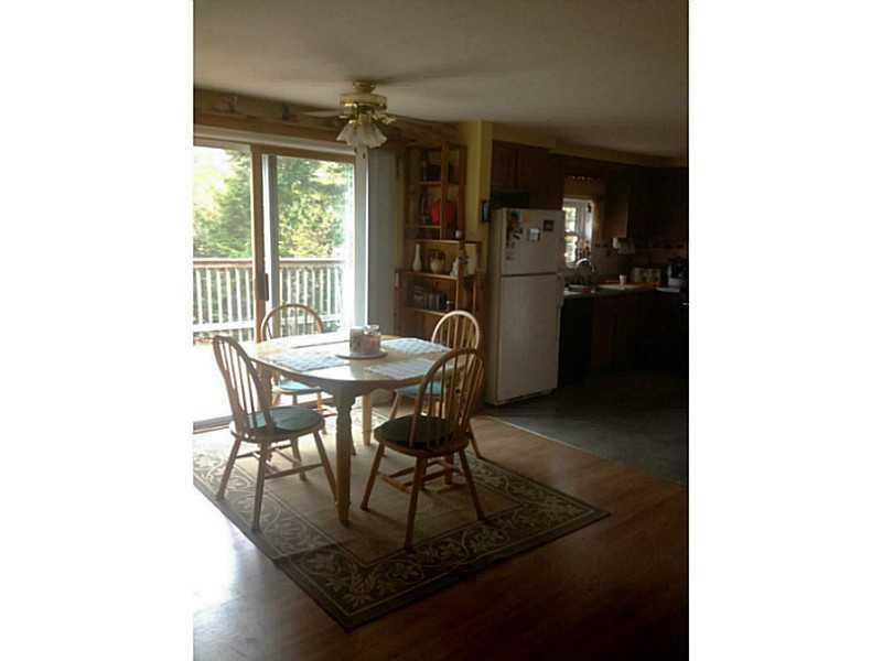 410 Howard Pond Road Hanover, ME 04237 - Photo 6 of 17 Kitchen. Sliding glass doors open up...
