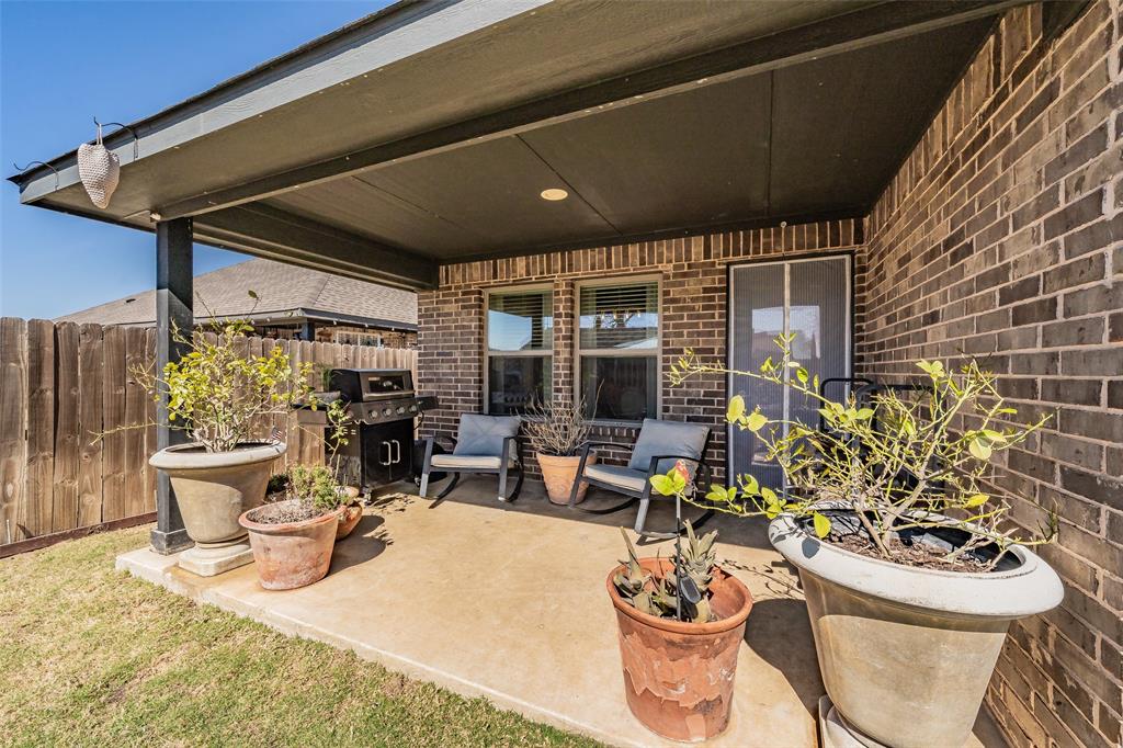141 Maverick Lane Pilot Point, TX 76258 - Photo 12 of 40 a outdoor dining space with a table and chairs and potted plants