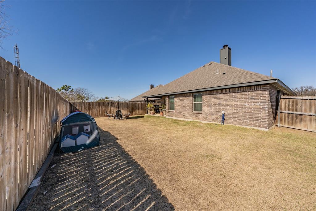 141 Maverick Lane Pilot Point, TX 76258 - Photo 14 of 40 a view of a house with wooden fence