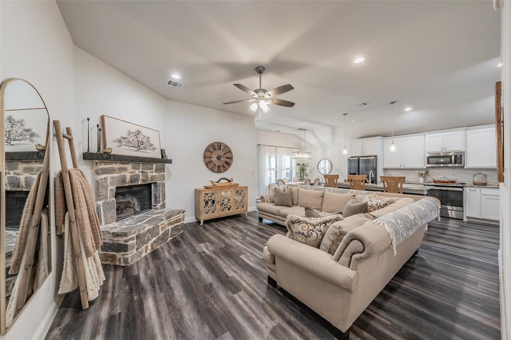 141 Maverick Lane Pilot Point, TX 76258 - Photo 16 of 40 a living room with furniture fireplace and kitchen view