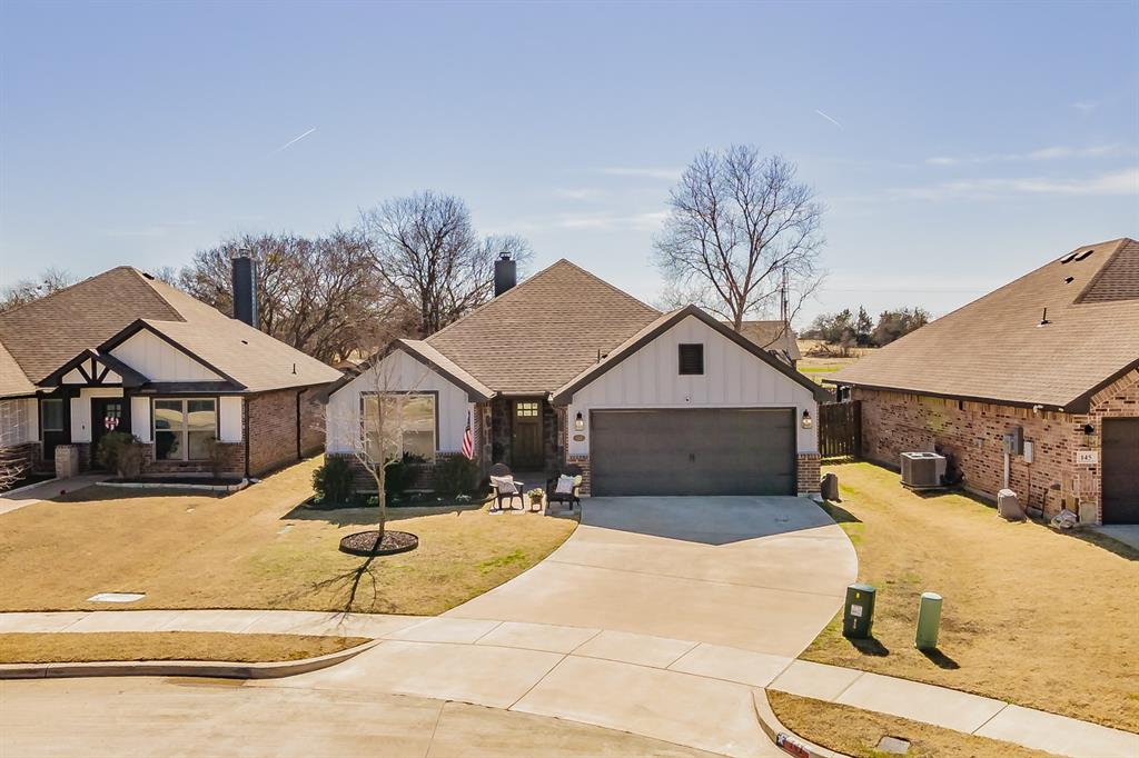 141 Maverick Lane Pilot Point, TX 76258 - Photo 3 of 40 a front view of a house with a yard