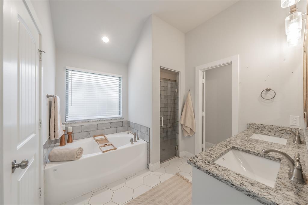 141 Maverick Lane Pilot Point, TX 76258 - Photo 34 of 40 a bathroom with a tub sink and mirror