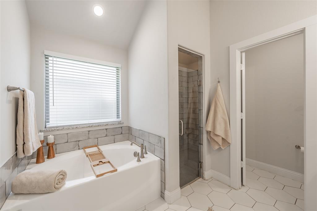 141 Maverick Lane Pilot Point, TX 76258 - Photo 35 of 40 a bathroom with a bathtub and a shower